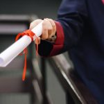 university student holding degree scroll